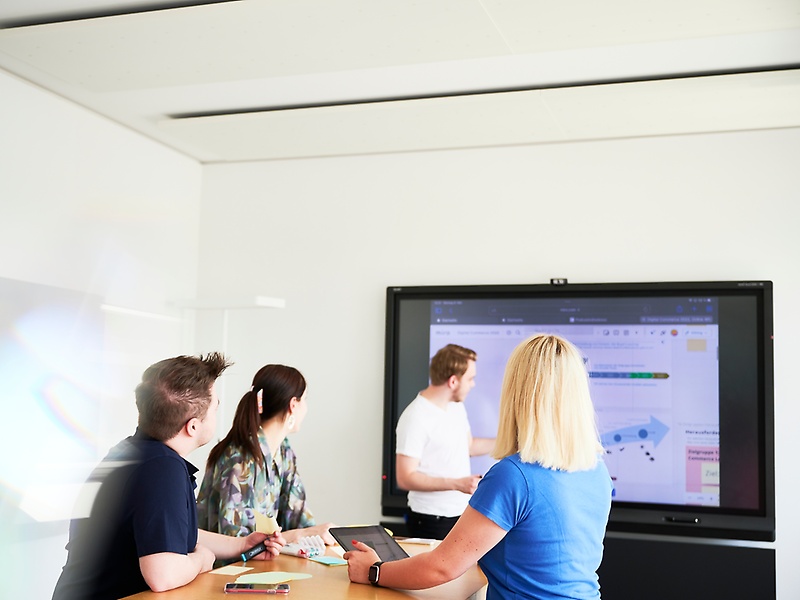 Employees working on a screen